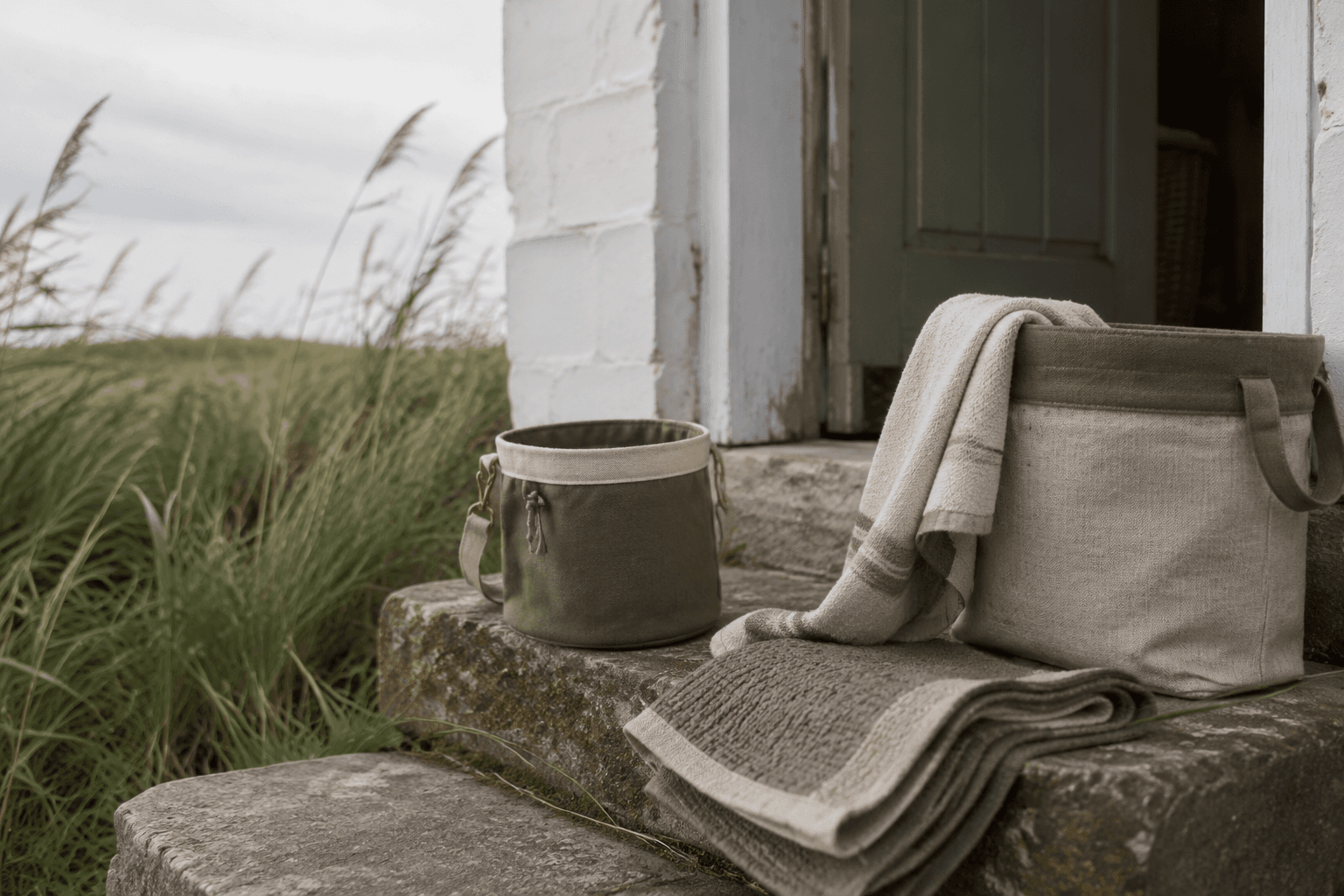 Walk pouch, washable mat, towel and storage bin on a Norfolk cottage doorstep